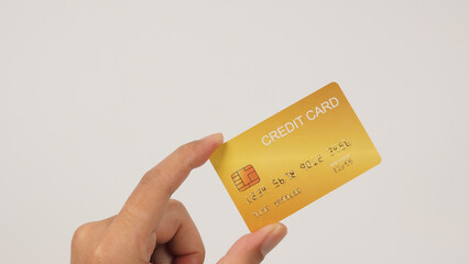 Hand is hold gold credit card on white background.