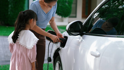 Progressive lifestyle of mother and daughter who have just returned from school in an electric...
