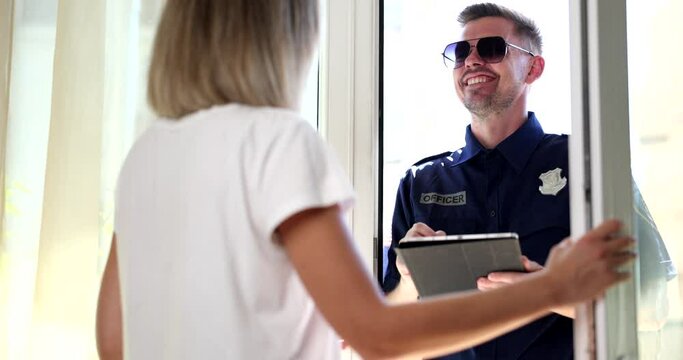 Policeman asking question to woman in her house 4k movie slow motion. Protection of houses and apartments concept