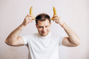 The guy is holding a banana in his hand. Men's health prostate prevention