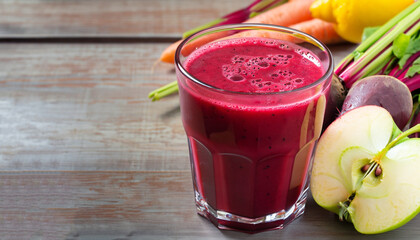 Healthy detox beetroot, carrot, apple and lemon juice smoothie in glass on wooden table, horizontal
