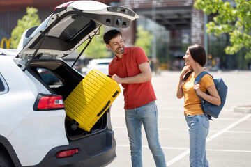 Happy man and woman partners travelling by car