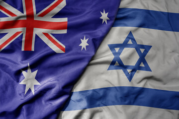 big waving realistic national colorful flag of australia and national flag of israel .