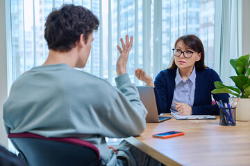 Guy student at therapy meeting with psychologist, mentor in college office