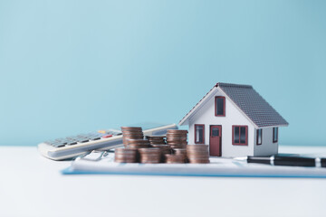 Property tax.investment planning.business real estate. View Of coin stack with house model,...