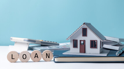 Property tax.investment planning.business real estate. View Of coin stack with house model,...