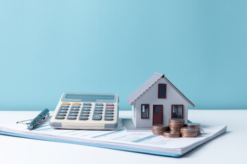 Property tax.investment planning.business real estate. View Of coin stack with house model,...