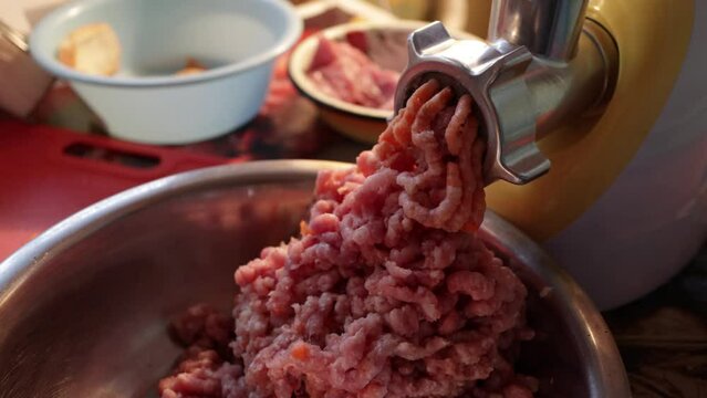 Grinding process in an electric meat grinder. Electro Meat grinder makes minced meat