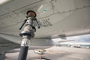 Close-up refueling of airplane at airport. Ground service before flight. .