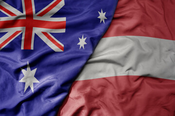 big waving realistic national colorful flag of australia and national flag of austria .