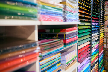 Still life with a shelf of color paper for design and creative hobby, displayed for sale in the school stationery shop