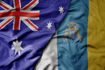 big waving realistic national colorful flag of australia and national flag of canary islands .