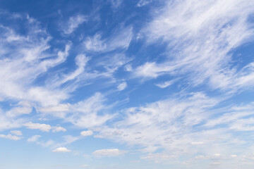 Beautiful soft gentle cloudy blue sky with white cirrus clouds, abstract background texture