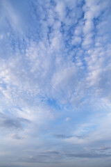 Beautiful epic soft gentle blue sky with white and grey cirrus and fluffy clouds background texture