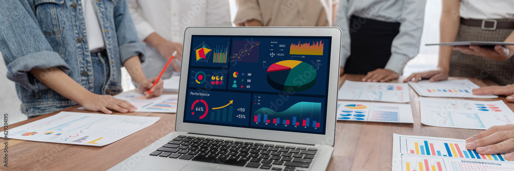 Leinwandbilder panorama shot analyst team utilizing bi fintech to analyze financial report with laptop. businesspeo