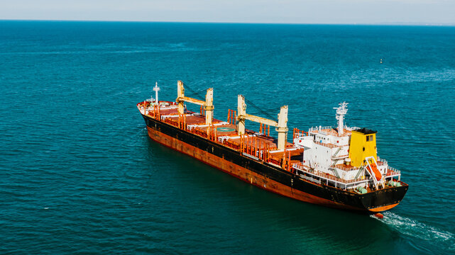 Cargo ship with grain sails on the sea, aerial view