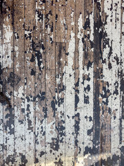 Distressed and vintage wooden surface with chipped white and black paint