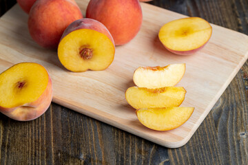 Ripe fresh peaches on a wooden table