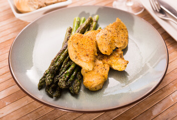 Dietary meal rich in protein. Stir fried chicken breast and green asparagus