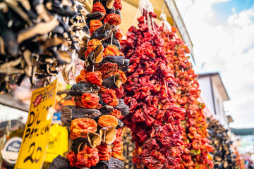 Dried eggplants and dried peppers on a string outside of a Turkish store
