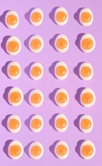 Top view of fried egg jelly candies on a purple background