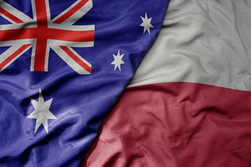 big waving realistic national colorful flag of australia and national flag of poland .