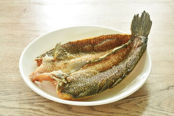 deep fried striped snake head fish with salt on plate