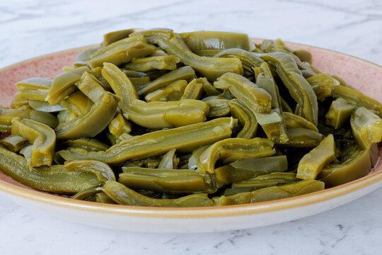 Nopales canned sliced cactus on a plate. Mexican cuisine ingredient.