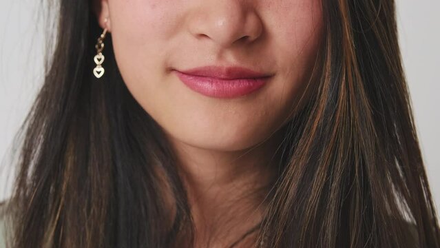 Detailed close-up shot of woman's smile taken in studio