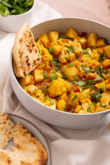 Delicious Aloo Gobi Masala stew: Authentic Indian Spicy Potato Cauliflower Curry with Exotic Spices and Nutritious Vegetables