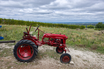 Obraz premium Red tractor near Monbazillac castle (Chateau de Monbazillac), Dordogne department, Aquitaine, France