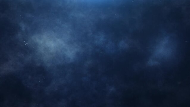 Blue Atmosphere Clouds and Particles 4K Loop  features blue clouds and particles flowing off screen in a black atmosphere in a loop.