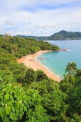 Fototapeta premium Tropical sandy beach landscape from high view point. Beautiful turquoise ocean and people relaxing in Laem Sing beach Phuket, Thailand