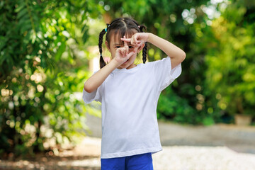 Portrait of cute asian girl with empty space of white t-shirt which good for mockup.