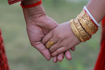 Close up image of newly married hindu couple holding hands of each other with love and trust,...
