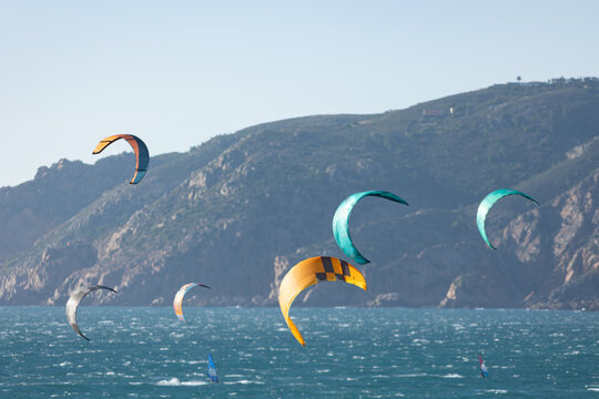 Colorful paragliders over the blue ocean