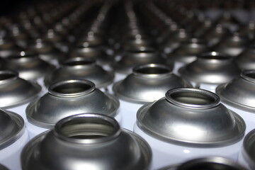 Empty aerosol cans awaiting manufacture in busy UK factory