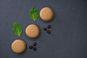 macaroons of different colors on a black background