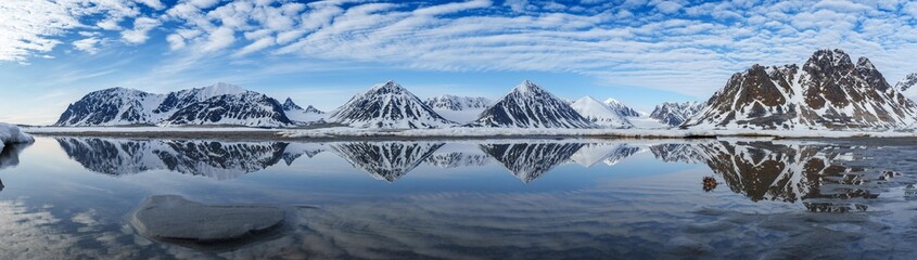 Reflection of snowcovered mountains in Svalbard
