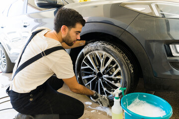 Auto service professional detail washing a customer's car