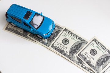 blue car on dollar notes on white