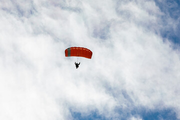 Parachute in the sky. Skydiver is flying a parachute in the blue sky