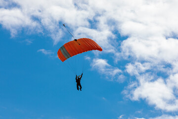 Parachute in the sky. Skydiver is flying a parachute in the blue sky