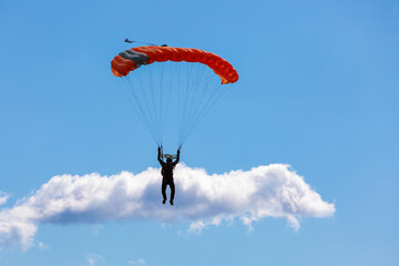 Parachute in the sky. Skydiver is flying a parachute in the blue sky
