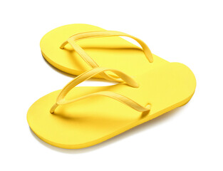 Pair of yellow flip-flops on white background