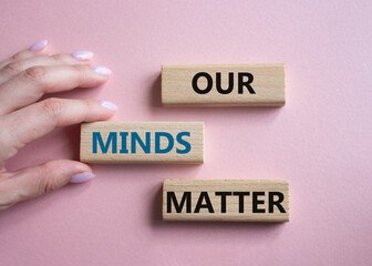 Our Minds Matter symbol. Concept words Our Minds Matter on wooden blocks. Doctor hand. Beautiful pink background. Psychological social and Our Minds Matter concept. Copy space.