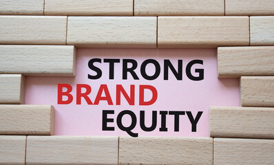 Strong Brand Equity symbol. Concept words Strong Brand Equity on wooden blocks. Beautiful pink background. Business and Strong Brand Equity concept. Copy space