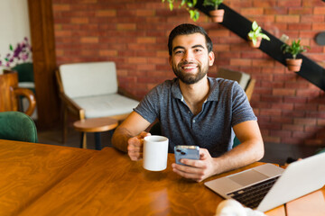 Smiling attractive man happy about his remote freelance work