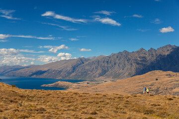 Mature backpacking couple hiking in remote mountainous landscape