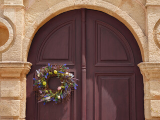 travel to city of Lindos on island of Rhodes, Greece. decoration for Easter, a wreath with flowers...